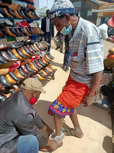 A herder from the Ethiopian/Kenyan Borderlands buys a pair of shoes.